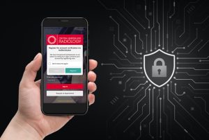 Hand holding phone with IQ Vue Patient app details on the screen against black background