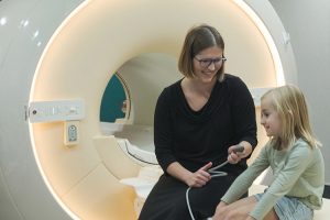 MRI technician preparing young patient to go for an MRI scan