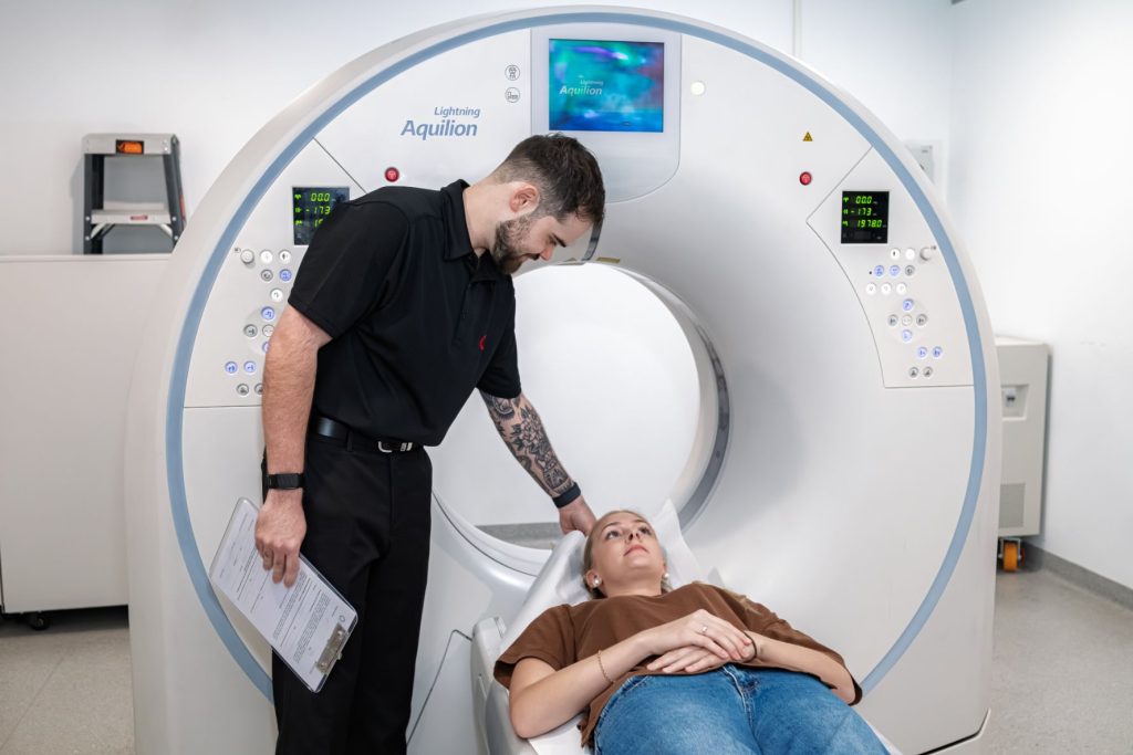 CT Radiographer supports female patients going into CT scan at Central Queensland Radiology