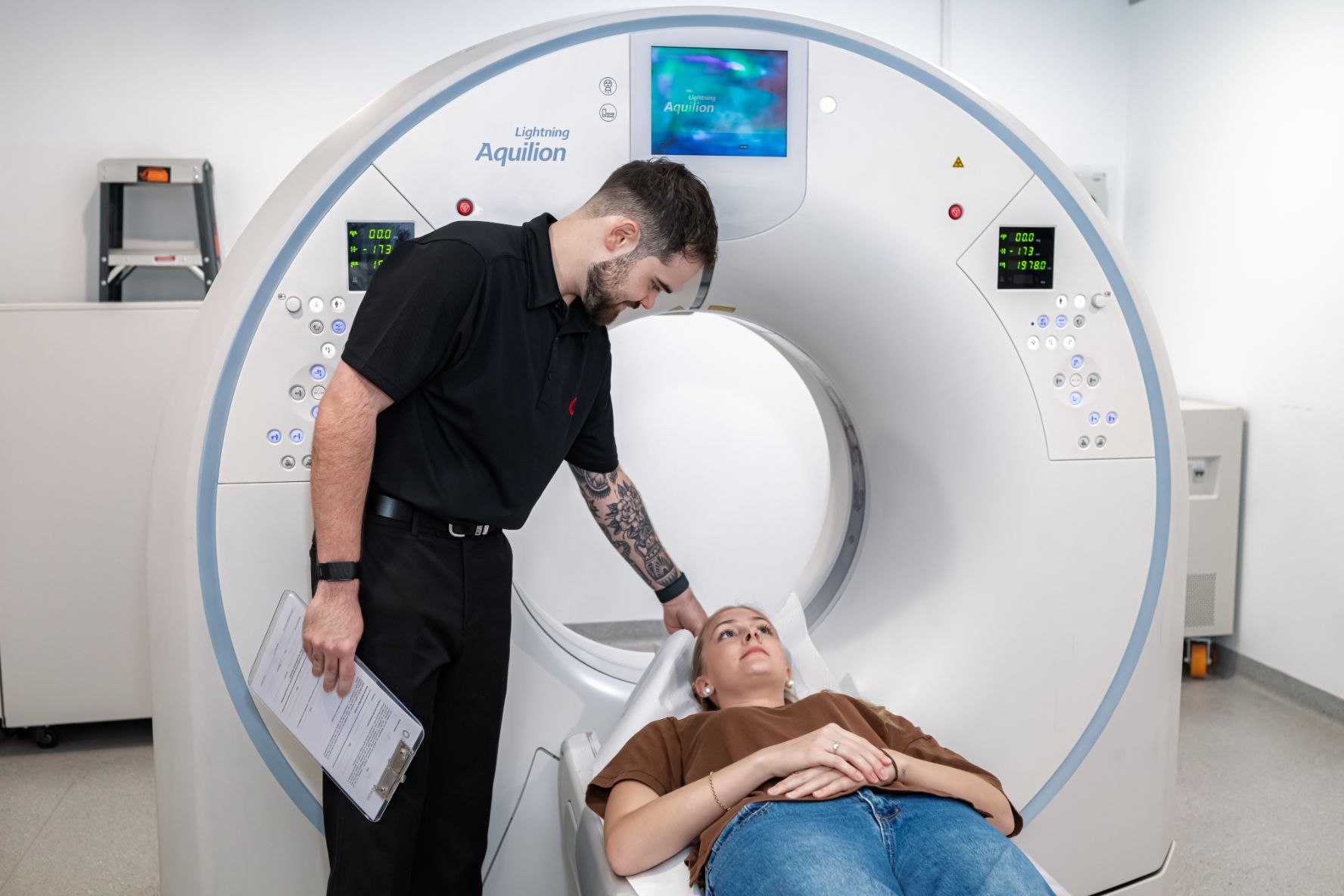 CT Radiographer supports female patients going into CT scan at Central Queensland Radiology