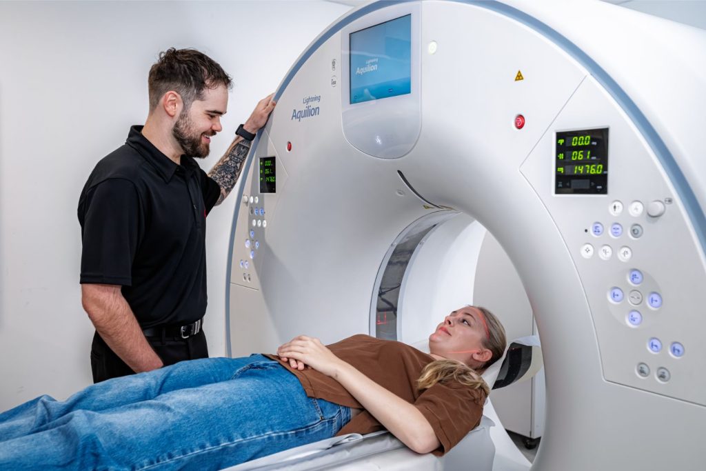 Radiographer at Central Queensland Radiology supports patient going into a CT scan