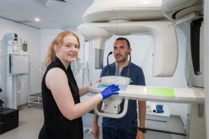 Radiographer prepares to do OPG dental imaging on male patient