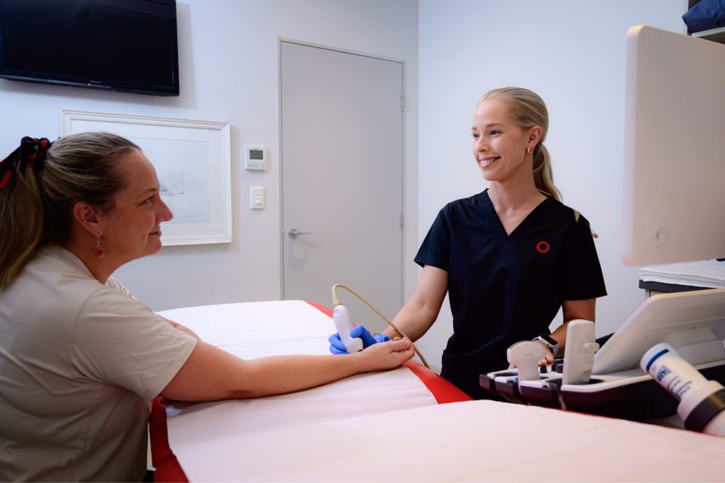 Ultrasonographer does wrist ultrasound for female patient at Central Queensland Radiology