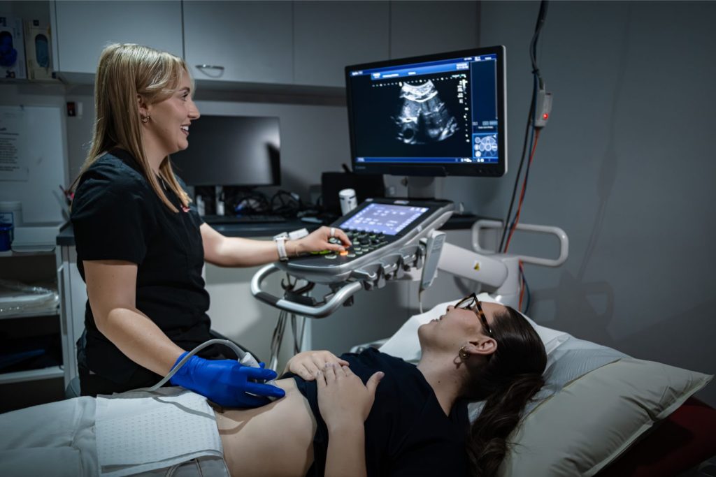 Ultrasonographer performs and abdominal ultrasound on a female patient at Central Queensland Radiology